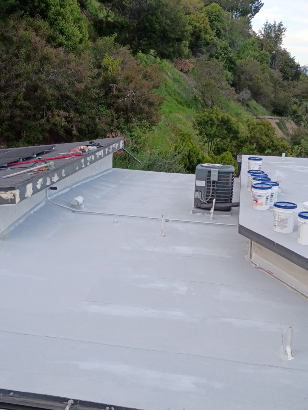 Roof coating on a hillside home