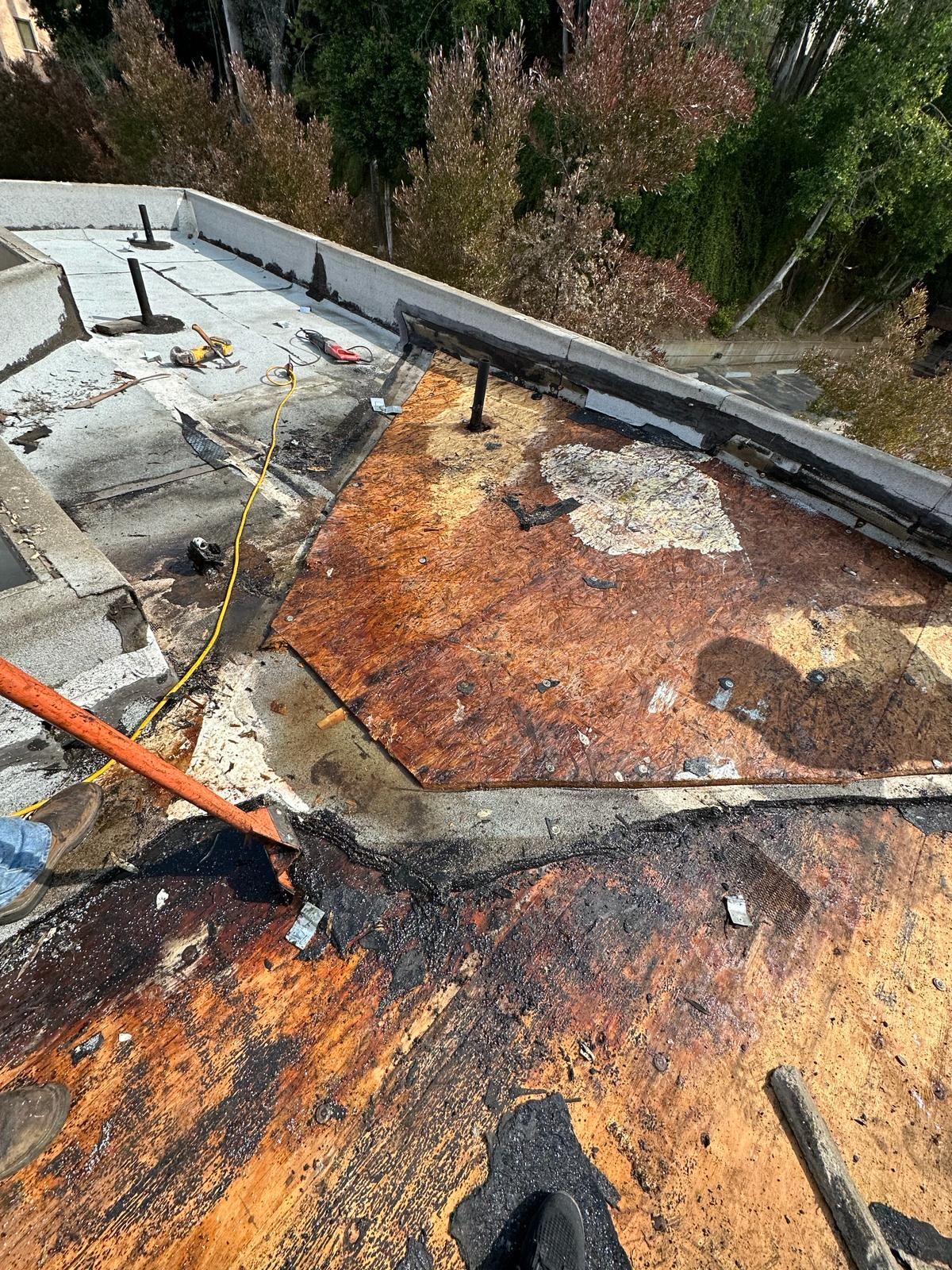 Rotted flat roof deck being replaced before the new roof