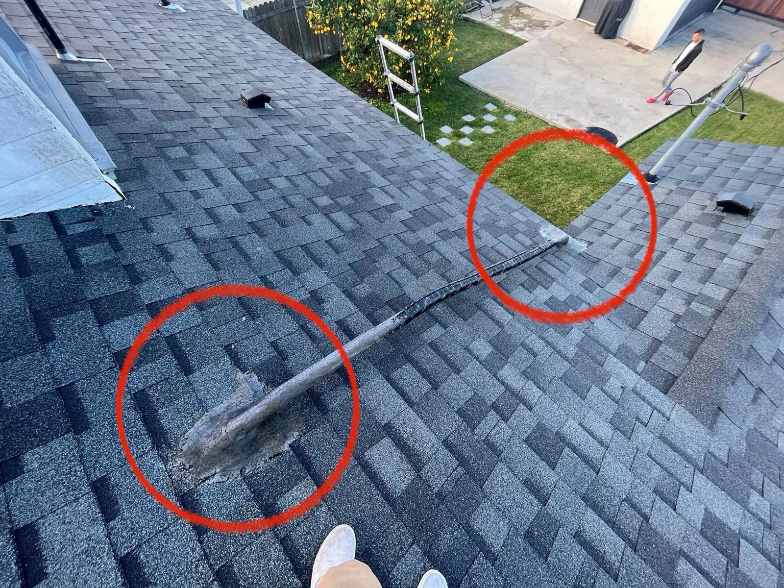 Problem areas marked on a shingle roof