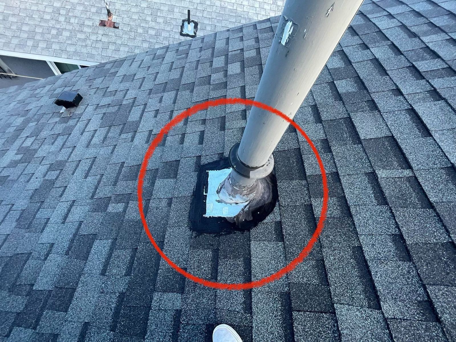 Pipe flashing patched with tar