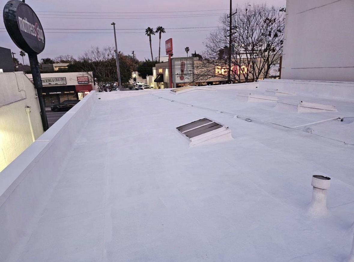 White silicone coating on a commercial roof