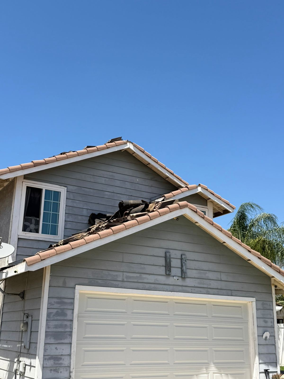 Tile roof repair on a two-story home