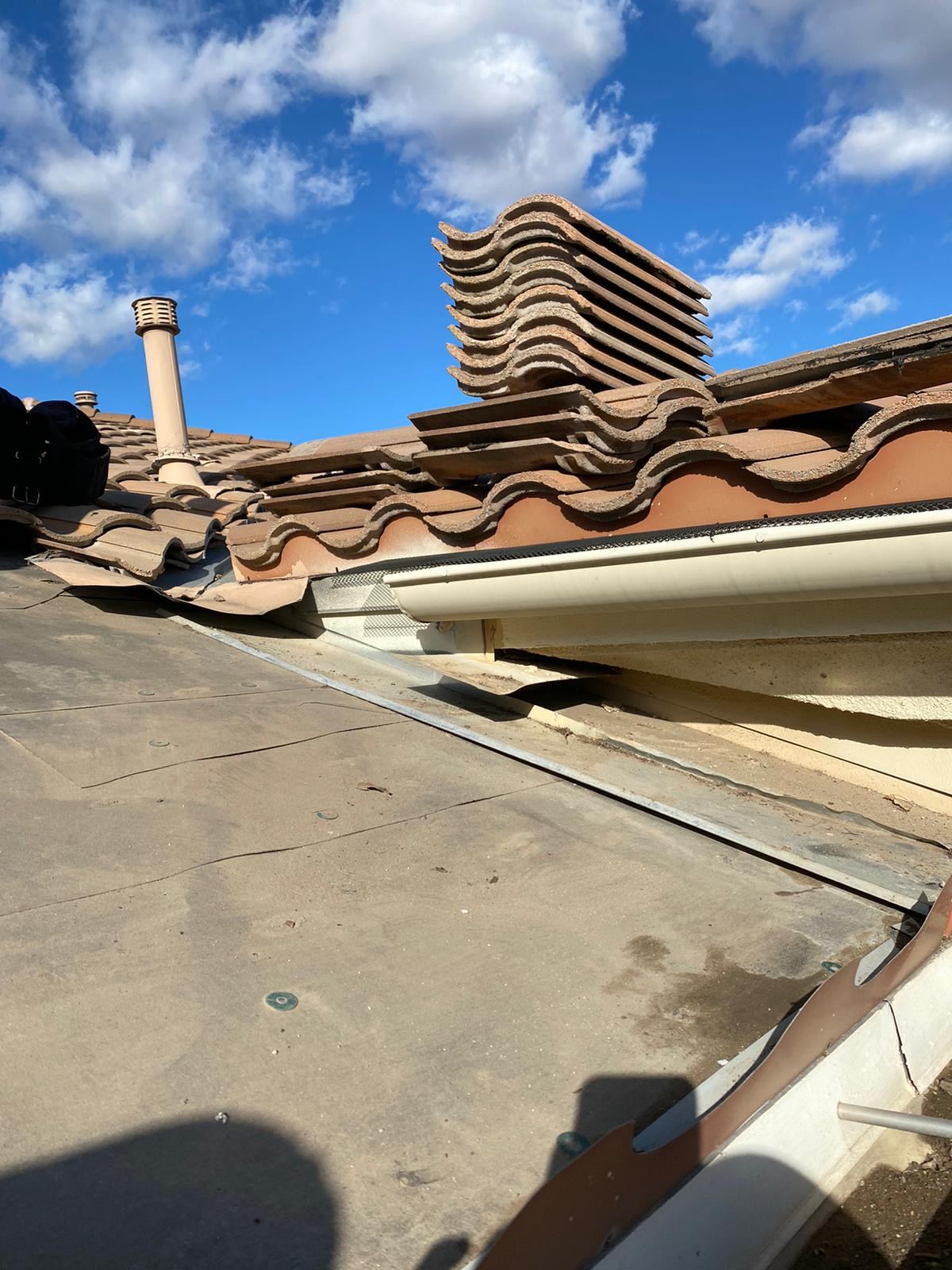 Clay tiles stacked during a tile roof re-lay with new underlayment